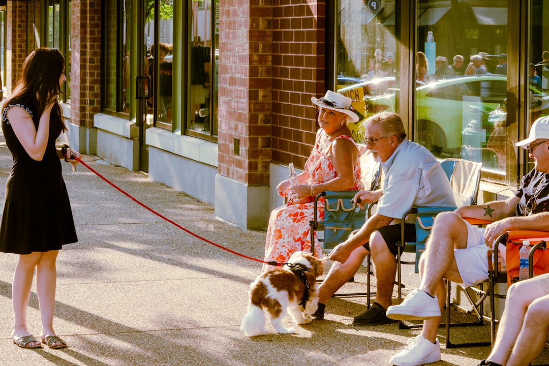 a-woman-walking-a-dog-down-a-street-6onc53dafpw